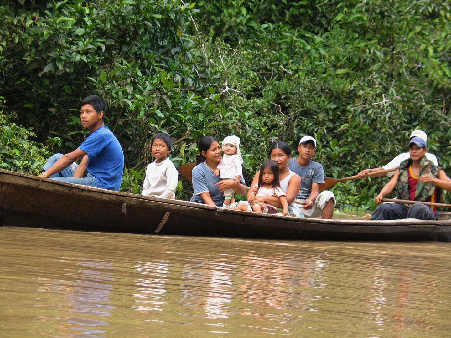 A family on a boat along the Amazon River