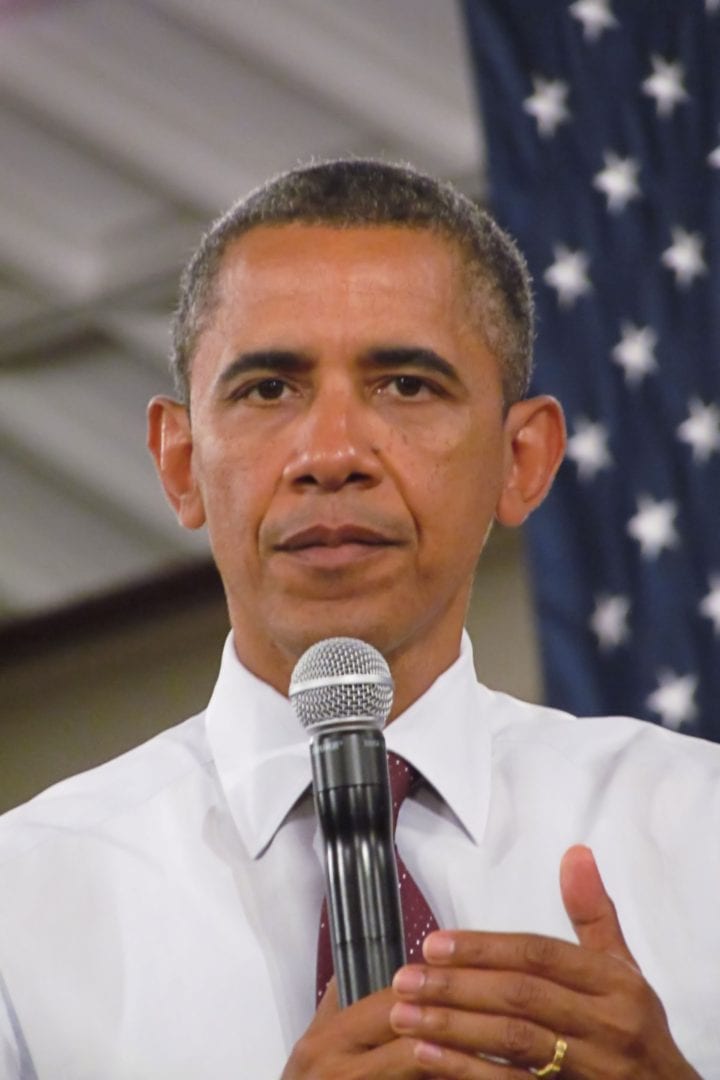 Barrack Obama holding a microphone