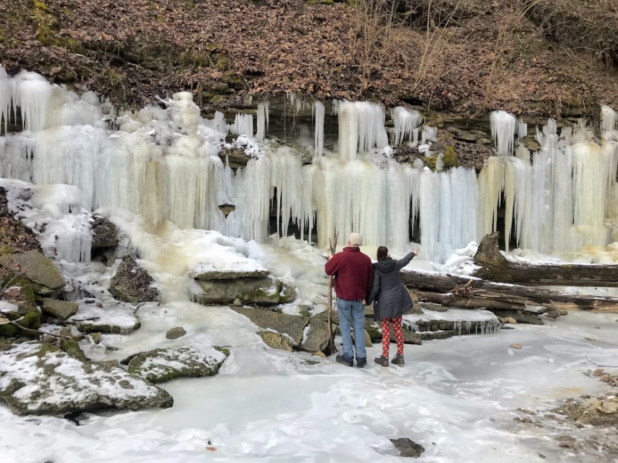 A couple standing on a frozen river