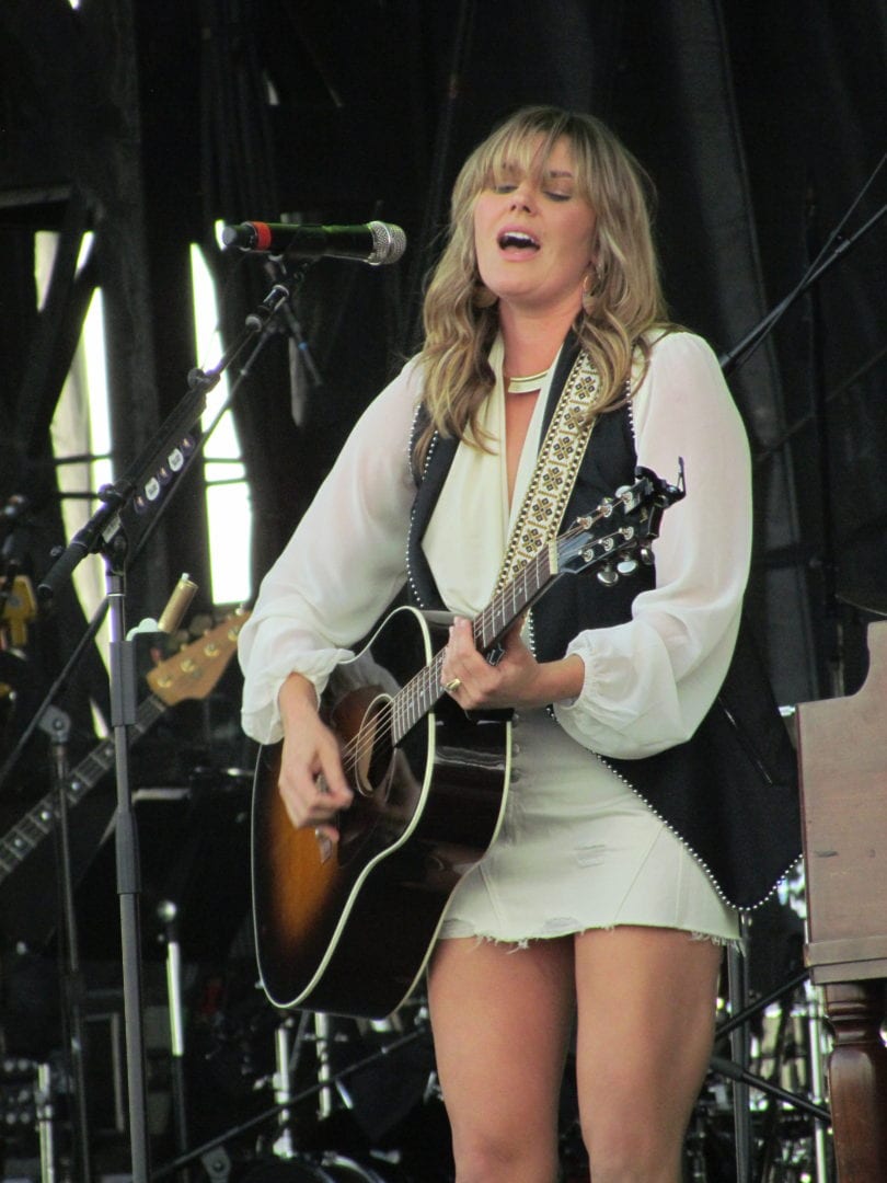 Grace Potter sings while playing guitar